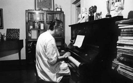 Satyajit Ray with his piano