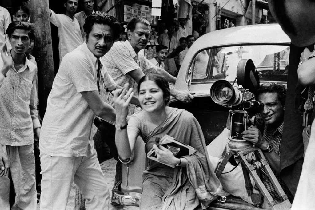 Ray behind the camera with crew and assistant director Suhasini Mulay on location for The Middleman (1975) ©Nemai Ghosh